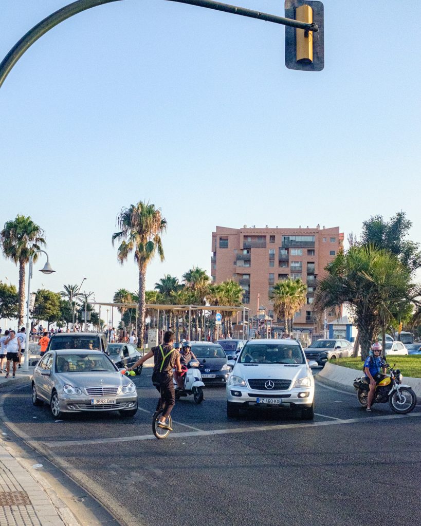 Each time the traffic light turned red this daredevil rushed into traffic to juggle on a unicycle. Crazy.